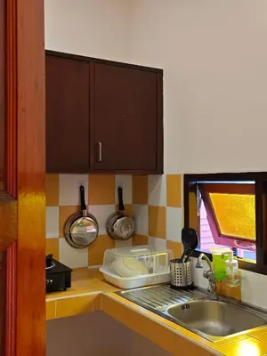a kitchen with a sink and a counter top at Tangerine Villa Patong in Patong Beach