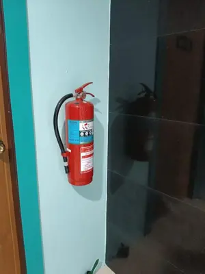 a fire extinguisher is hanging on a wall at \u82ad\u4e1c\u4e00\u5367\u5927\u5e8a\u623f\u72ec\u7acb\u6dcb\u6d74\u9633\u53f0 in Patong Beach