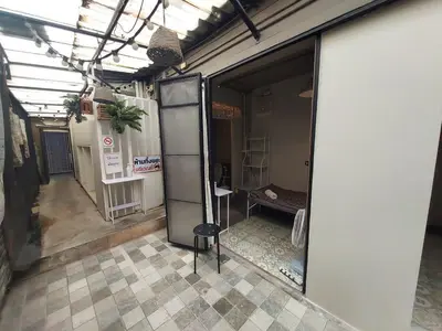 an empty room with a glass door in a building at FanRoomGroundFlNonehotshower in Ban Ket Ho