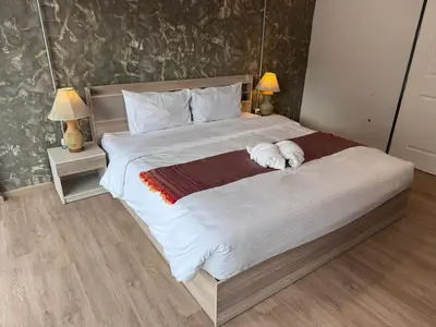 a large bed with two dogs laying on it at Global Hills View in Patong Beach