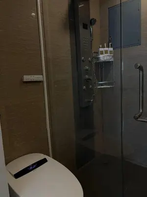a bathroom with a toilet and a glass shower at Luxury villa with sea view, pool and maid in Patong Beach