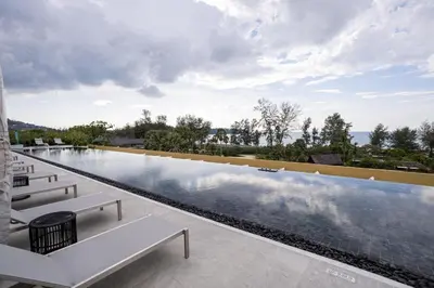 a swimming pool with a view of the ocean at Premium 1BR Laguna, 200m to the Beach in Bang Tao in Bang Tao Beach