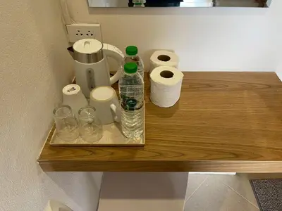 a wooden shelf with toilet paper and a coffee maker at Acacia Phuket in Nai Harn Beach