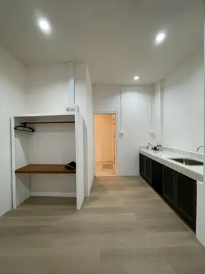 a white kitchen with a sink and a counter at Acacia Phuket in Nai Harn Beach