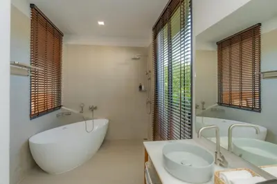 a bathroom with a large tub and two sinks at URMI VILLA, Brand New Luxury 6BR Pool, Bang Tao in Koh Lone