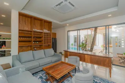 a living room with a couch and a table at URMI VILLA, Brand New Luxury 6BR Pool, Bang Tao in Koh Lone