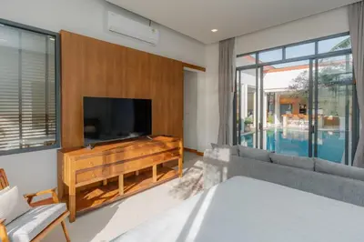 a living room with a television and a couch at URMI VILLA, Brand New Luxury 6BR Pool, Bang Tao in Koh Lone