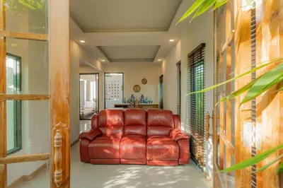 a brown leather reclining chair in a living room at URMI VILLA, Brand New Luxury 6BR Pool, Bang Tao in Koh Lone
