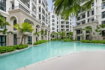 a swimming pool in the middle of a building with palm trees at Delos 1BR Suite — The Title Legendary BangTao in Bang Tao Beach