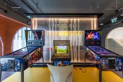 two arcade games on display in a room at Delos 1BR Suite — The Title Legendary BangTao in Bang Tao Beach