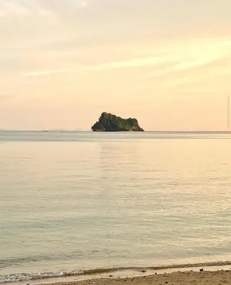 an island in the middle of the ocean with a beach at Ja Mia's Bungalow at Pasai Beach in Ko Yao Noi