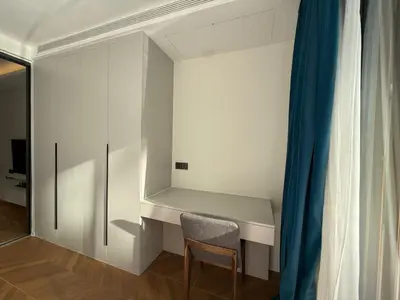 a white room with a chair and a desk at Sunshine BEACH FRONT access to the pool in Layan Beach