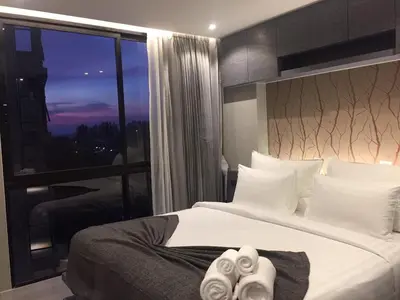 a bedroom with a large bed and a large window at luxury apartment at Kamala in Kamala Beach