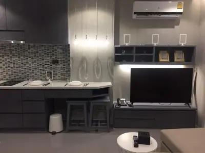 a kitchen with a tv and a counter with a sink at luxury apartment at Kamala in Kamala Beach