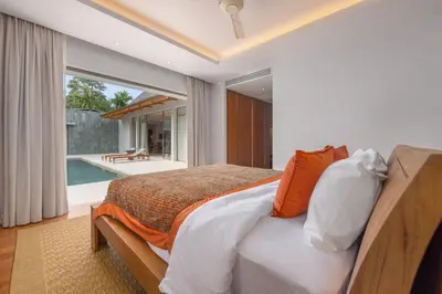 a bedroom with a bed and a swimming pool at Private 3BR Pool Villa Mana at Anchan Tropicana in Ban Phru Champa