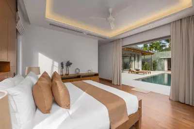 a bedroom with a white bed and a swimming pool at Private 3BR Pool Villa Mana at Anchan Tropicana in Ban Phru Champa