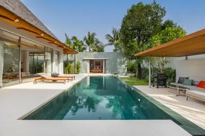 an infinity pool in a backyard with a house at Private 3BR Pool Villa Mana at Anchan Tropicana in Ban Phru Champa