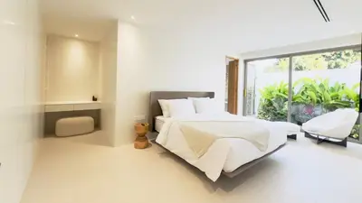 a white bedroom with a large bed and a window at The Coco Villa by Escape Villas - NEW tropical 2BR Pool Villa in Ban Riang