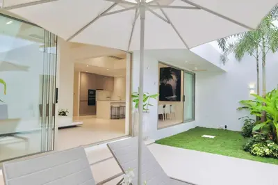 an open living room with an umbrella in a house at The Coco Villa by Escape Villas - NEW tropical 2BR Pool Villa in Ban Riang