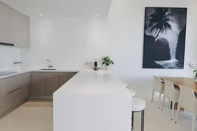 a kitchen and dining room with a table and chairs at The Coco Villa by Escape Villas - NEW tropical 2BR Pool Villa in Ban Riang