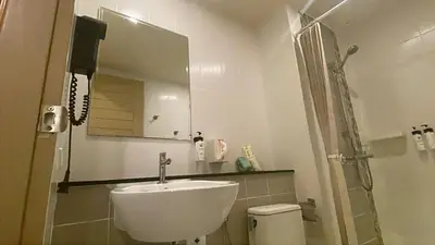 a bathroom with a sink and a shower at The Rock Poshtel Patong in Patong Beach
