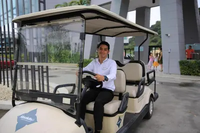 a man is driving a golf cart at Resort Sea View Apartment Patong in Patong Beach