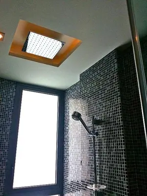 a bathroom with a shower with a light and a window at Resort Sea View Apartment Patong in Patong Beach