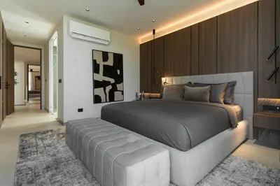 a bedroom with a large bed with a bench in it at Grand View Family Villa 5 min to Beach in Ban Thalat Choeng Thale