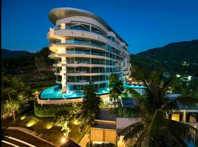 a large building with a swimming pool in front of it at Karon Beach Forest View in Ban Karon