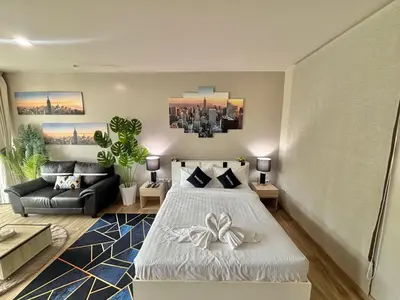 a living room with a bed and a couch at Karon Beach Forest View in Ban Karon