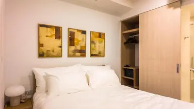 a bedroom with a bed with white pillows at Apartment 2 bedrooms in SkyPark in Laguna Phuket