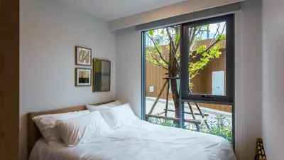 a bedroom with a bed and a large window at Apartment 2 bedrooms in SkyPark in Laguna Phuket