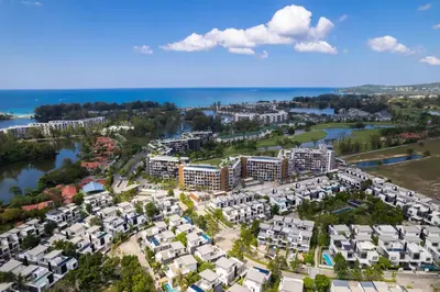 an aerial view of a large apartment complex next to the water at Apartment 2 bedrooms in SkyPark in Laguna Phuket