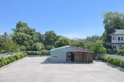 a parking lot with a shed in the middle of a yard at The Homey Boutique Rawai in Ban Nong Chaeng