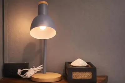 a lamp sitting on a table next to a box at The Homey Boutique Rawai in Ban Nong Chaeng