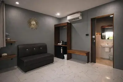 a waiting room with a chair and a sink at The Homey Boutique Rawai in Ban Nong Chaeng