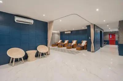 a lobby with chairs and tables and blue walls at Citygate condo at Kamala Beach in Kamala Beach