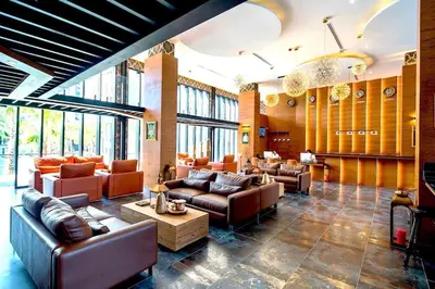 a living room with couches and tables and windows at Citygate condo at Kamala Beach in Kamala Beach