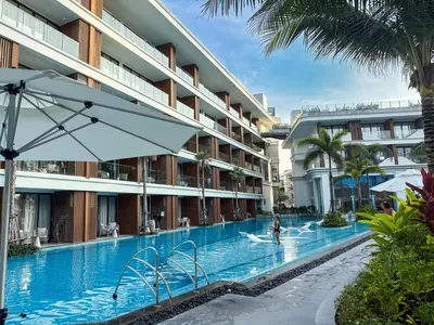 a swimming pool at a resort with a person in the water at Sunshine Layan Beach Resort 1 bedroom #84196 in Layan Beach