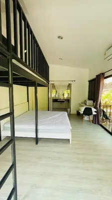a bedroom with a bunk bed and a desk at บ้านสกุลลี-House of Lee in Ban Huai Sai