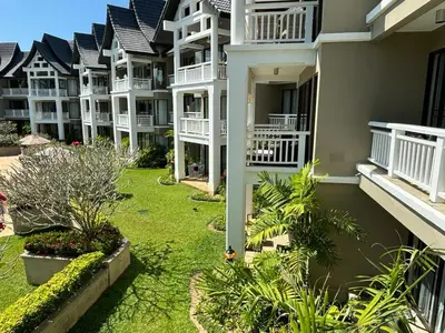 a row of apartment buildings with a yard at Allamanda 2 Laguna Phuket luxuries 1 bedroom in Laguna Phuket