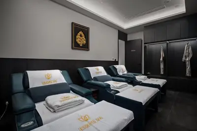 a room with four beds and chairs in it at Hydra 1BR Suite at Kora Beach Resort in Layan Beach