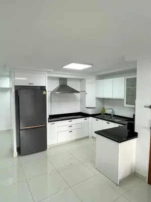 a kitchen with white cabinets and a stainless steel refrigerator at Seaview paradise in Patong Beach