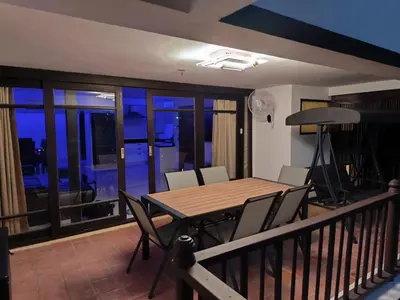 a dining room with a table and chairs on a balcony at Seaview paradise in Patong Beach