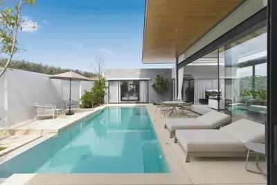 a swimming pool in a house at Botanica Pru Jampa by Beringela in Phuket