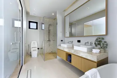 a bathroom with two sinks and a shower at Botanica Pru Jampa by Beringela in Phuket