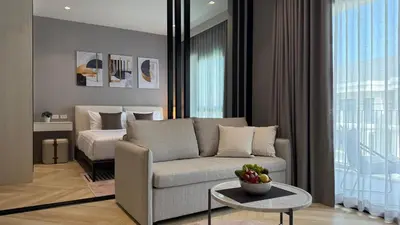 a living room with a couch and a bed at Cozy Apartment 1 km to Bangtao beach in Bang Tao Beach