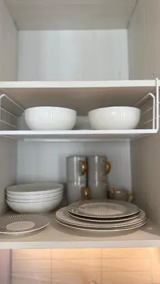 a cabinet filled with plates and bowls and dishes at Cozy Apartment 1 km to Bangtao beach in Bang Tao Beach