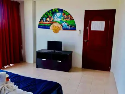 a room with a room with a door and a tv at TK Apartment By Wijitra in Ban Saiyuan (1)