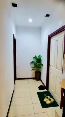 a hallway with a door and a pair of sandals on the floor at TK Apartment By Wijitra in Ban Saiyuan (1)